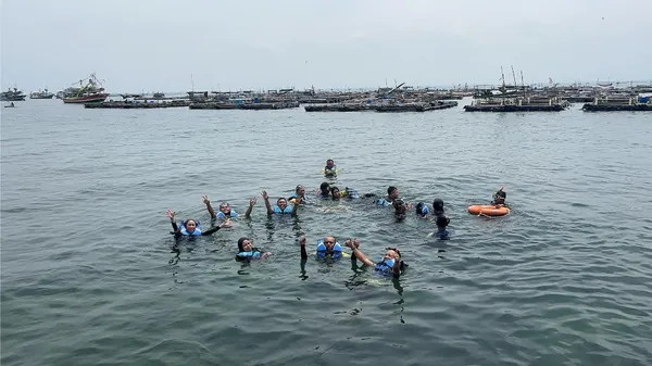 Menikmati hidangan spesial ikan bakar khas pulau di pinggir pantai bersama rombongan